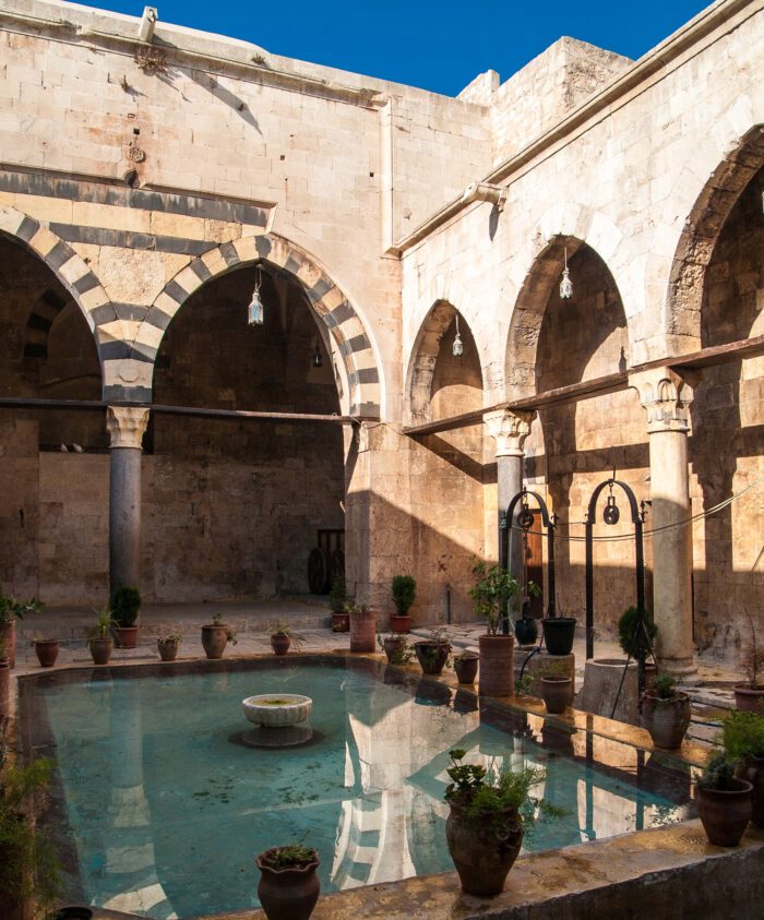 Al-Bimaristan al-Arghuni, 14th-century Mamluk hospital in Aleppo, Syria, providing medieval psychiatric care.